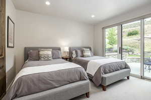 Carpeted bedroom with access to exterior