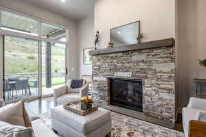 Living room with a fireplace and light hardwood / wood-style flooring