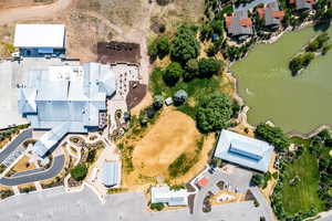 Birds eye view of property with a water view