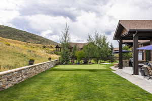 View of yard with a mountain view and a patio