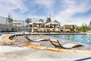 View of pool with a gazebo and pool water feature