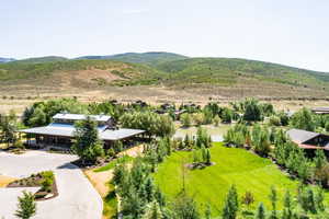 Birds eye view of property featuring a water and mountain view