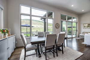 Dining room featuring a healthy amount of sunlight and dark wood-type flooring