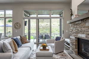 Living room with a wealth of natural light, a fireplace, and wood-type flooring