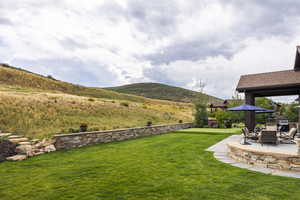 View of yard with a mountain view and a patio area