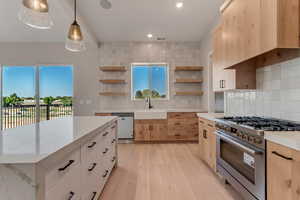 Kitchen with stove and vent (this owner upgraded to hardwood floors on the main level)