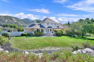 Back of property featuring a yard and a mountain view