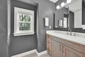 Bathroom with tile patterned floors and vanity