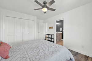 Bedroom with ceiling fan, a closet, hardwood / wood-style flooring, and ensuite bath