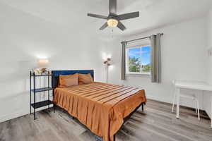 Bedroom with wood-type flooring and ceiling fan