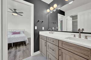 Bathroom featuring vanity, ceiling fan, hardwood / wood-style floors, and walk in shower