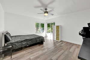 Bedroom featuring ceiling fan and light hardwood / wood-style floors