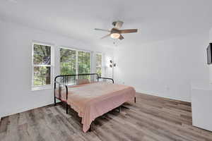 Bedroom featuring hardwood / wood-style floors and ceiling fan