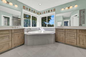 Bathroom featuring vanity, independent shower and bath, and tile patterned floors