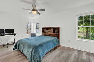 Bedroom with light hardwood / wood-style flooring and ceiling fan