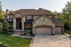 View of front of house featuring a garage and a front yard