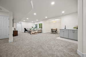 Carpeted living room with sink