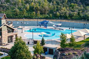 View of pool with a water slide and a patio