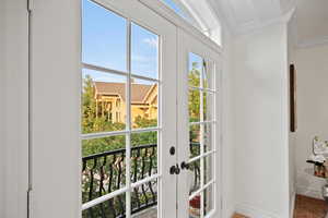 Doorway to outside featuring ornamental molding and hardwood / wood-style floors