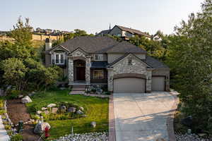 French provincial home with a front yard and a garage