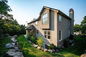 View of home's exterior featuring a lawn and central air condition unit