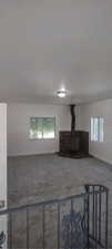 Living room with a healthy amount of sunlight and a wood stove