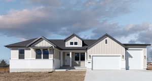 View of front facade featuring a garage and a porch