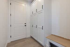 Mudroom with light hardwood / wood-style flooring