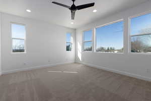 Carpeted spare room with ceiling fan