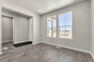 Unfurnished room featuring a textured ceiling and hardwood / wood-style floors