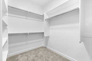 Spacious closet with light colored carpet