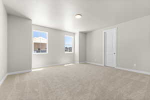 Carpeted empty room featuring a textured ceiling