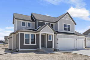 View of front of property featuring a garage and covered porch