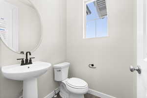 Bathroom featuring wood-type flooring and toilet