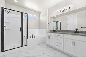 Bathroom featuring a textured ceiling, shower with separate bathtub, and vanity