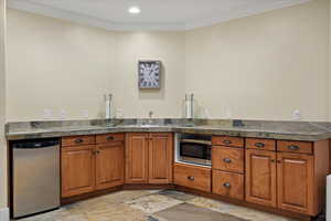 Kitchen featuring ornamental molding, stainless steel appliances, and sink