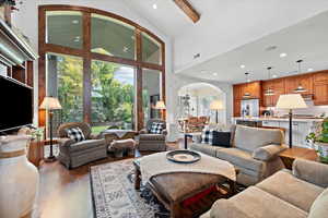 Living room featuring hardwood / wood-style floors and high vaulted ceiling