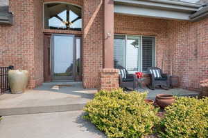 Doorway to property featuring a patio