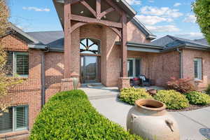 View of exterior entry featuring a patio