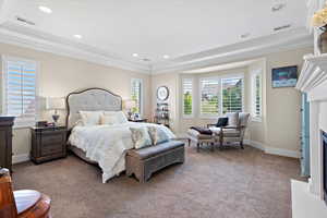 Bedroom featuring crown molding and light carpet