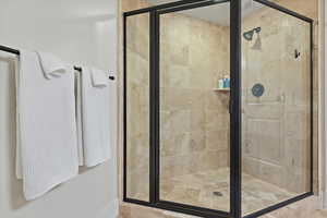 Bathroom featuring a shower with door