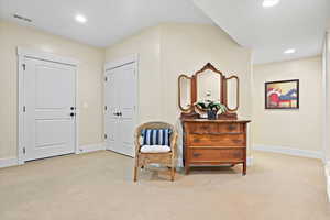 Living area with light colored carpet