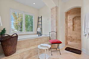 Bathroom featuring independent shower and bath and tile patterned flooring