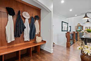 Mudroom featuring crown molding and wood-type flooring