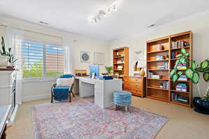 Interior space featuring light carpet and crown molding