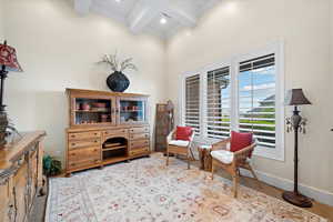 Sitting room featuring crown molding and beamed ceiling