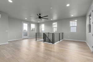 Spare room featuring ceiling fan and light hardwood / wood-style floors