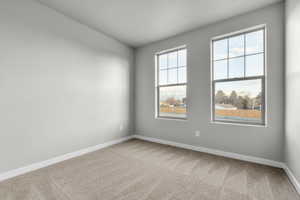 Unfurnished room with a healthy amount of sunlight and light colored carpet