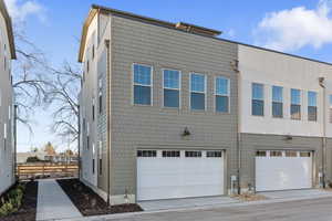 View of back of property with a garage