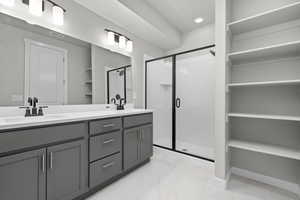 Bathroom featuring vanity and a shower with door